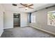 Bedroom with gray carpet flooring, a ceiling fan, and two windows for natural light at 280 Gentry St, Overton, NV 89040