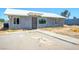 Cozy, single-story home with a modern metal roof and a secure front entrance gate at 280 Gentry St, Overton, NV 89040