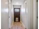 Hallway with wood flooring, wood front door with pet door at 280 Gentry St, Overton, NV 89040
