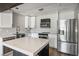 Well-lit kitchen with stainless steel appliances, white cabinets, and a functional island at 280 Gentry St, Overton, NV 89040