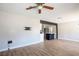 Open-concept living room featuring wood-look floors, a ceiling fan, and an island with bar seating at 280 Gentry St, Overton, NV 89040
