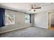 Spacious main bedroom with two windows, ceiling fan, and carpet flooring at 280 Gentry St, Overton, NV 89040