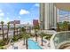 Balcony overlooking a pool surrounded by palm trees, lush landscaping, and views of surrounding buildings at 2857 Paradise Rd # 401, Las Vegas, NV 89109