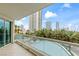 Balcony view featuring palm trees, landscaping, and high rise buildings on the horizon at 2857 Paradise Rd # 401, Las Vegas, NV 89109