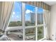 The bedroom provides natural light and a scenic view of surrounding buildings and lush greenery at 2857 Paradise Rd # 401, Las Vegas, NV 89109