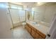 Bathroom with tiled floor, single sink vanity, decorative walls and shower with glass doors at 2906 Cedar Ave, Las Vegas, NV 89101