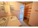 Bathroom features large mirror, single sink vanity, and adjacent shelved closet at 2906 Cedar Ave, Las Vegas, NV 89101