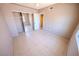 Bedroom with a closet with sliding mirror doors, base molding, and tile flooring at 2906 Cedar Ave, Las Vegas, NV 89101