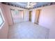 Bedroom features mirrored closet doors, tile flooring, base molding and neutral paint at 2906 Cedar Ave, Las Vegas, NV 89101