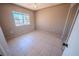 Bedroom features neutral paint, tile flooring, double door closet and bright window at 2906 Cedar Ave, Las Vegas, NV 89101