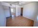 Bright bedroom featuring wood-look floors, white walls, ceiling fan, and mirrored closet at 2906 Cedar Ave, Las Vegas, NV 89101