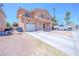 Two-story home with covered porch, white garage door, long driveway, and desert landscaping at 2906 Cedar Ave, Las Vegas, NV 89101