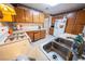 Kitchen with laminate countertops, wood cabinets, white appliances, and tile flooring at 2906 Cedar Ave, Las Vegas, NV 89101