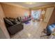 Living room features tile flooring, neutral paint, couches, and natural light at 2906 Cedar Ave, Las Vegas, NV 89101