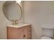 Bathroom showcasing a vanity with quartz counters and a large round mirror at 3386 El Camino Real, Las Vegas, NV 89121