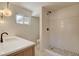 Bright bathroom featuring a large, tiled shower, natural stone floors, and quartz countertop at 3386 El Camino Real, Las Vegas, NV 89121