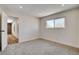 Bedroom features carpet, baseboard, window, neutral paint and a doorway to the hall at 3386 El Camino Real, Las Vegas, NV 89121