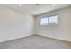 Bright, carpeted bedroom featuring base moulding and large window at 3386 El Camino Real, Las Vegas, NV 89121