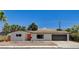 Charming single story home with desert landscaping and an orange front door at 3386 El Camino Real, Las Vegas, NV 89121