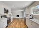 Lovely kitchen offering stainless steel appliances, white cabinets, quartz countertops, and direct view of fireplace at 3386 El Camino Real, Las Vegas, NV 89121
