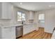 Beautiful kitchen featuring white cabinets, quartz countertops, stainless steel dishwasher, and a black faucet at 3386 El Camino Real, Las Vegas, NV 89121