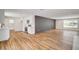 Open floor plan with wood flooring and modern white kitchen cabinets at 3386 El Camino Real, Las Vegas, NV 89121
