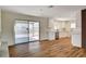 Open living room with wood floors, modern cabinets, and sliding glass door to patio at 3386 El Camino Real, Las Vegas, NV 89121