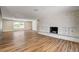 Open living room with wood floors and a unique stone fireplace at 3386 El Camino Real, Las Vegas, NV 89121