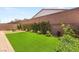 The backyard features green turf and lush landscaping, creating a serene and inviting outdoor space at 3395 Stone View Ave, Henderson, NV 89044
