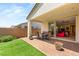 Outdoor patio with dining set, synthetic grass, and slider door into living room at 3395 Stone View Ave, Henderson, NV 89044