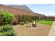 Enjoy the serene backyard, featuring lush landscaping, gravel, and a fire pit area for cozy evenings at 3395 Stone View Ave, Henderson, NV 89044