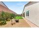 This backyard features a gravel area with a fire pit, lawn, and landscaping for relaxing and entertaining at 3395 Stone View Ave, Henderson, NV 89044