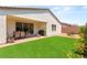 The backyard offers a covered patio, lawn, and gravel area with room for seating and landscaping at 3395 Stone View Ave, Henderson, NV 89044
