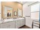 Bright primary bathroom features granite counters, double sinks, a large window and modern fixtures at 3395 Stone View Ave, Henderson, NV 89044