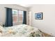 Inviting bedroom featuring a large window and comfortable bed with floral comforter at 3395 Stone View Ave, Henderson, NV 89044