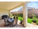 The covered patio features a dining area and overlooks a lush lawn with decorative landscaping at 3395 Stone View Ave, Henderson, NV 89044