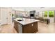 Spacious kitchen island with seating, a stainless steel dishwasher and ample counter space with backyard views at 3395 Stone View Ave, Henderson, NV 89044