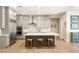 Modern kitchen boasts a large center island with seating, stainless steel appliances, and light grey cabinets at 3395 Stone View Ave, Henderson, NV 89044