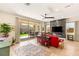 Bright living room featuring a marble fireplace, flat screen TV, wood floors and an open door to a covered patio at 3395 Stone View Ave, Henderson, NV 89044
