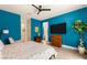 Stylish bedroom features blue walls, a mounted flat screen TV, and modern furnishings at 3395 Stone View Ave, Henderson, NV 89044