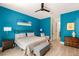 Stylish bedroom features blue walls, modern ceiling fan, and sleek contemporary furnishings at 3395 Stone View Ave, Henderson, NV 89044