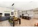 Open concept living space with kitchen island, dining area and integrated custom cabinetry for storage or display at 3395 Stone View Ave, Henderson, NV 89044