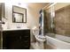 Traditional bathroom with a tub, shower, and a dark vanity with a mirror at 3890 Lancome St, Las Vegas, NV 89115