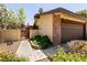 Exterior of home featuring gated access to small yard and brick facade on garage at 3890 Lancome St, Las Vegas, NV 89115