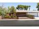 Charming single-story home with a brick facade, gated front yard, and mature trees at 3890 Lancome St, Las Vegas, NV 89115