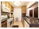 Kitchen with tiled floors, granite countertops, and stainless steel and white appliances at 3890 Lancome St, Las Vegas, NV 89115