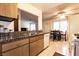 Cozy kitchen featuring tiled floors, granite countertops, and dining area with natural light at 3890 Lancome St, Las Vegas, NV 89115