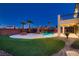 Expansive backyard with pool, rock waterfall, and tiki hut; perfect for entertaining and enjoying outdoor living at 3892 Pasilla Ave, Las Vegas, NV 89118