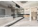 Modern bathroom with a glass shower, separate tub, and wooden vanity with dual sinks at 3892 Pasilla Ave, Las Vegas, NV 89118