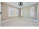 A bright bedroom with white trim, plantation shutters, and modern ceiling fan at 3892 Pasilla Ave, Las Vegas, NV 89118